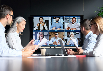 Group discussion with conference call screen in the background