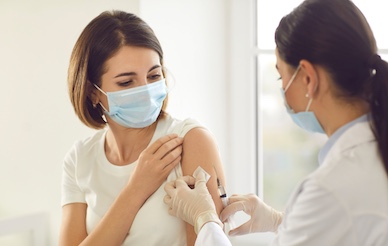 Woman receiving vaccine in upper arm